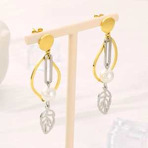 Orecchini a pendente a foglia in oro e argento con perle bianche su un supporto minimalista