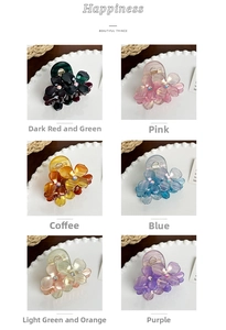 Detail showing six colorful acetate flower hair claws with sparkling crystal centers