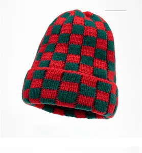 Close-up of thick checkered knit beanie with festive red and green pattern and fold-over cuff