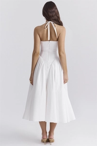 Detail of a white halter midi dress featuring a low back design and invisible zipper closure
