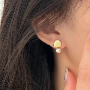Elegant 925 sterling silver brushed gold pearl stud earrings worn by a model