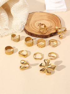 Detail view of an 11-piece 18k gold plated ring set featuring petal and geometric designs