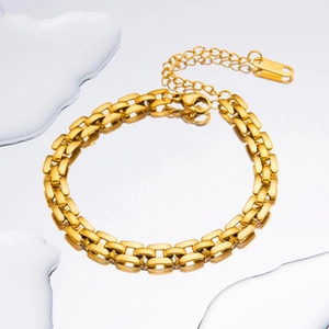 Detailed close-up of gold chain bracelet with lobster clasp and adjustable extension link