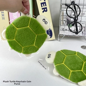 Detail of plush turtle coin purse with yellow hexagonal pattern and white belly