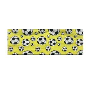 Close-up of elastic yellow sports headband with black and white football patterns
