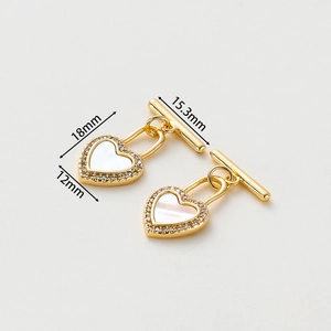 Macro view of 14k gold-plated heart OT toggle clasp with mother of pearl and zircons