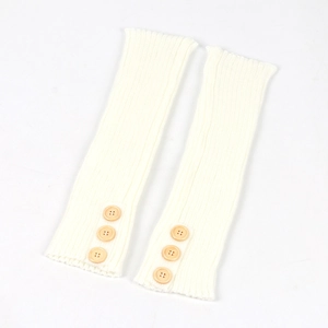 Detail of white ribbed knit leg warmers with decorative brown wooden buttons