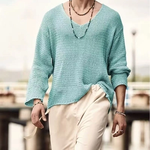 Close-up of light blue hollow knit sweater showing breathable texture and V-neck detail