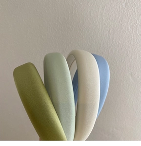 Detail of colorful matte padded headbands in olive, mint, beige and soft blue colors