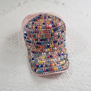 Close-up of pink baseball cap featuring colorful pearls and silver rhinestone embellishments