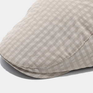 Close-up of British plaid flat cap showing high-quality stitching and fabric texture