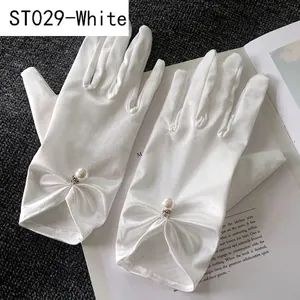 Detailed view of white satin bridal gloves featuring a silk bow and elegant pearl accent
