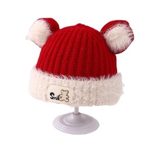 Winter knit hat for children with red body, white plush ears and a Smile bear tag