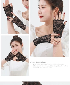 Close-up of black floral lace fingerless gloves showing rose patterns and mesh texture