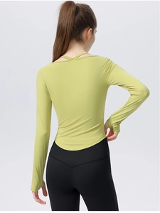 Slim-fit avocado green yoga top featuring a crisscross neckline and stylish curved hemline