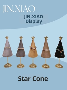 Set of five velvet cone jewelry stands with golden star tops and metal bases