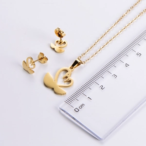 Gold swan jewelry set necklace and earrings with ruler measuring 2cm pendant size