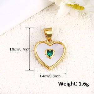 Macro detail of heart charm with white shell inlay, green zircon, and dimensions