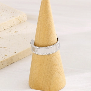 Minimalist silver geometric C-shaped open ring with bead edges on a wooden stand