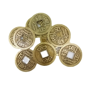 Detail of antique brass coins with square holes and traditional Chinese characters