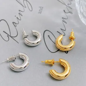Minimalist thick C-shape hoop earrings in polished gold and silver finishes