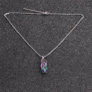 Detailed view of a hexagonal colorful crystal column pendant wrapped in silver wire