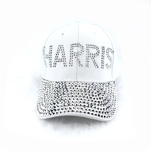 White baseball cap with Harris rhinestone letters and American flag pattern on the brim