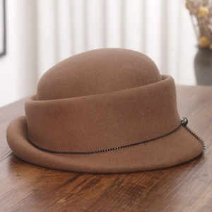 Detail of dark brown wool cloche hat with elegant black beaded chain and rolled brim