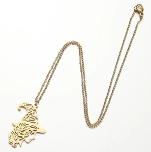 Macro detail of gold wizard pendant featuring hollow silhouette design and lobster clasp