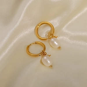 Detailed close-up of 18k gold plated hoop earrings with natural freshwater pearl stars