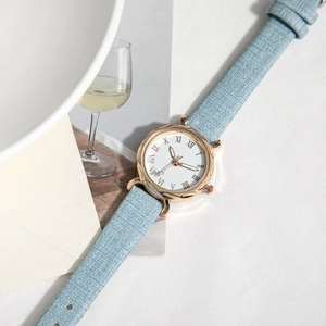 Minimalist quartz watch with light blue fabric strap and rose gold Roman numeral dial