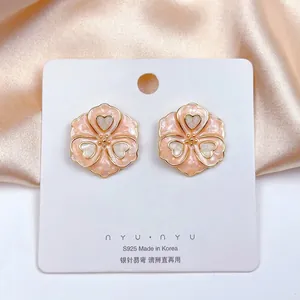 Detail of peach pink enamel flower earrings with gold edges and S925 silver needles