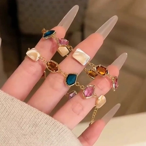 Colorful glass shell geometric square bracelet in gold finish worn on a wrist