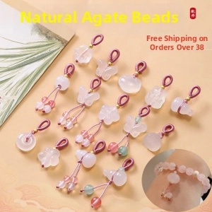 Macro detail of natural pink agate pendants in butterfly and flower shapes for jewelry
