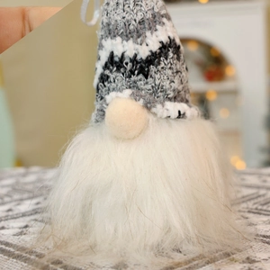 Macro shot of knitted grey gnome hat and soft plush beard for Christmas decor