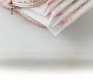Pink quilted cotton storage pouch for menstrual pads with cute heart pattern detail