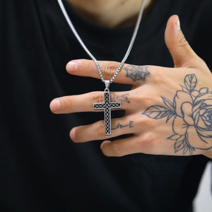 Vintage engraved stainless steel cross pendant necklace for men held by model