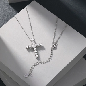 Close-up of S925 sterling silver cross pendant with zircon stones and hallmark detail