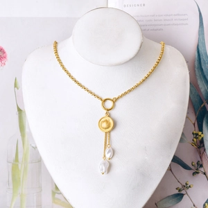Collier cœur doré avec pendentif en nacre et glands de perles baroques sur un mannequin