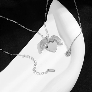 Collana cuore in acciaio inossidabile argento con ali d'angelo di strass su sfondo geometrico