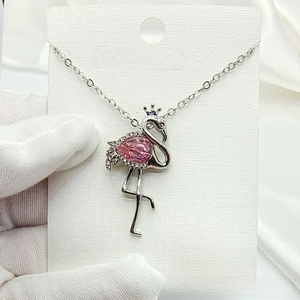 Close-up of flamingo pendant with pink pear-cut zircon and micro-set stones