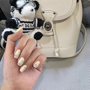 Cream yellow press-on nails with silver stars and rhinestones in medium square shape