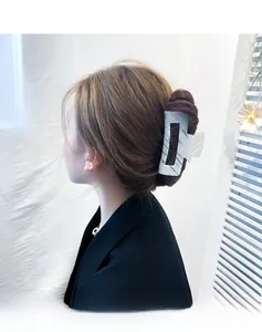 Detail showing marble texture rectangle hair claw clip on model in lifestyle setting
