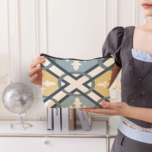 Portable geometric cosmetic bag with vintage fabric pattern and secure zipper closure