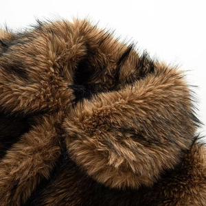 Close-up of thick faux fur texture on a brown winter trapper hat showing high-quality fibers