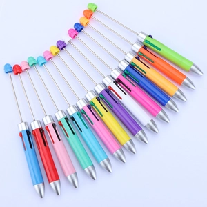 Creative multi-colored DIY beaded pens in vibrant assorted colors on a white background
