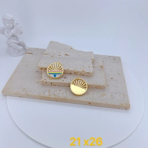 Detailed view of evil eye charms in gold finish on stone plate with size dimensions