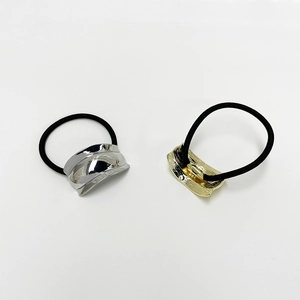Minimalist elastic hair ties with sleek gold and silver metal buckles on white background
