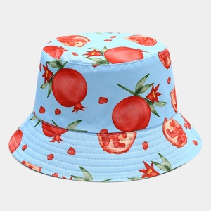 Close-up of sky blue bucket hat featuring vibrant watercolor pomegranate patterns and stitching