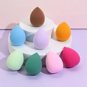 Set of 8 colorful teardrop makeup sponges displayed on a white tiered platform